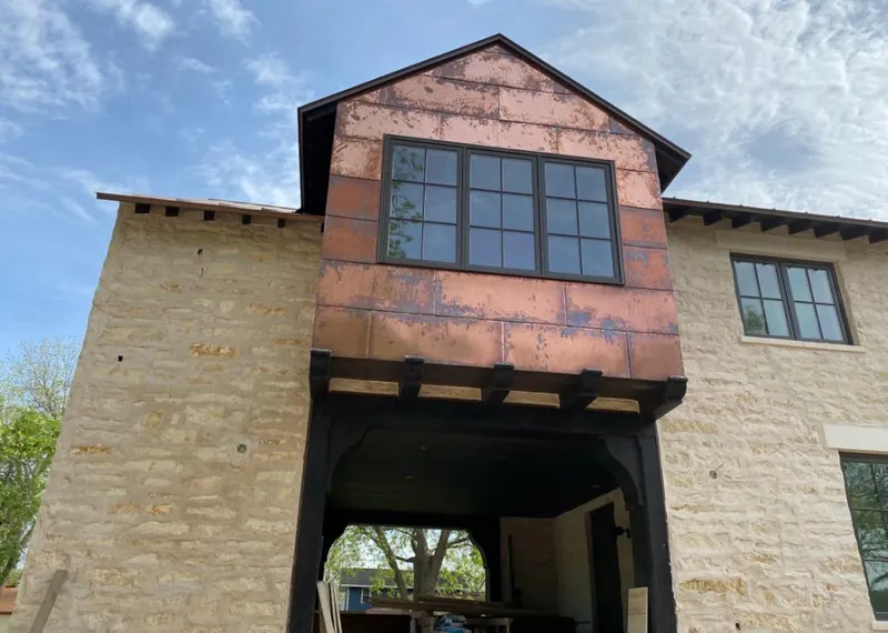 Copper metal panel facade on a stone building for Roof Repair in Tifton